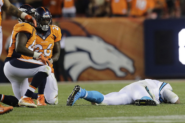 In this Sept. 8, 2016, file photo, Carolina Panthers quarterback Cam Newton (1) lies on the turf after a roughing the passer penalty was called on Denver Broncos free safety Darian Stewart (26) du ...