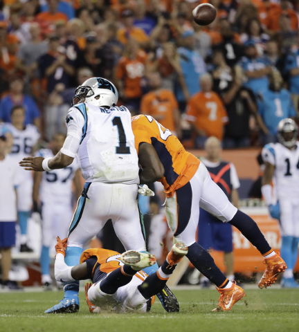 In this Sept. 8, 2016, file photo, Denver Broncos free safety Darian Stewart (26) hits Carolina Panthers quarterback Cam Newton (1) late for a penalty during the second half of an NFL football gam ...