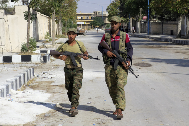 In this Aug. 31, 2016 file photo, Free Syrian Army fighters patrol in Jarablus, Syria. Five years of failed efforts to quell the fighting in Syria have persuaded many observers that the war, incon ...
