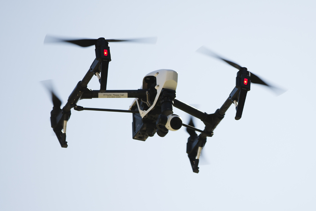 FILE - In this April 14, 2016 file photo, a drone captures videos and still images of an apartment building in Philadelphia. Federal aviation officials say so many people are registering drones an ...