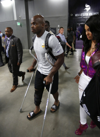 Minnesota Vikings running back Adrian Peterson leaves U.S. Bank Stadium on crutches after an NFL football game against the Green Bay Packers Sunday, Sept. 18, 2016, in Minneapolis. The Vikings won ...