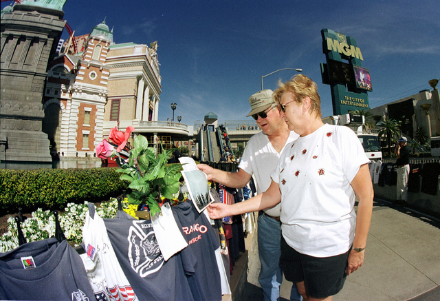 On the six month anniversary of the attack on the World Trade Centers, Rick and Phoebe Letzring of Cavalier, ND stop to look at some of the many tee shirts and letters that decorate the front of N ...