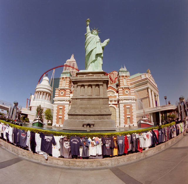 Tourists pay their respects to the victims of the 9/11 attack on New York City by placing tee shirts from fire departments all over the country in front of the New York New York hotel-casino in La ...