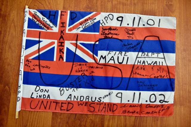 A personalized Hawaii state flag from the New York-New York Hotel and Casino's 9-11 heroes tribute memorial Wednesday, Sept. 7, 2016, in Las Vegas. The library, with financial assistance from MGM  ...