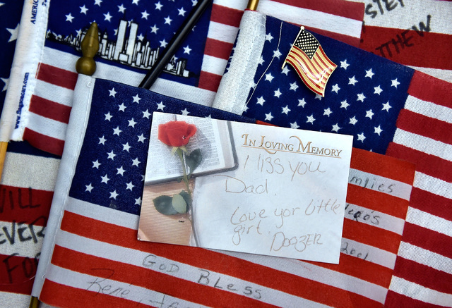 American flags and a personalized note card gathered from the New York-New York Hotel and Casino's 9-11 heroes tribute memorial Wednesday, Sept. 7, 2016, in Las Vegas. The library, with financial  ...