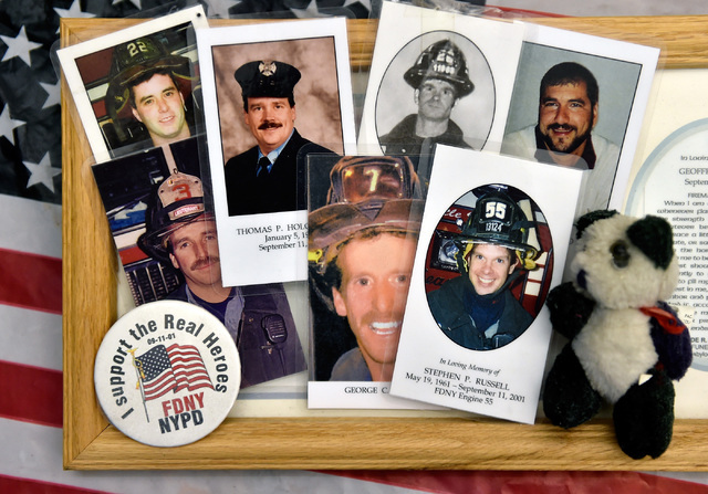 Memorial mass cards with photographs of fallen firefighters collected from the New York-New York Hotel and Casino's 9-11 heroes tribute memorial Wednesday, Sept. 7, 2016, in Las Vegas. The library ...