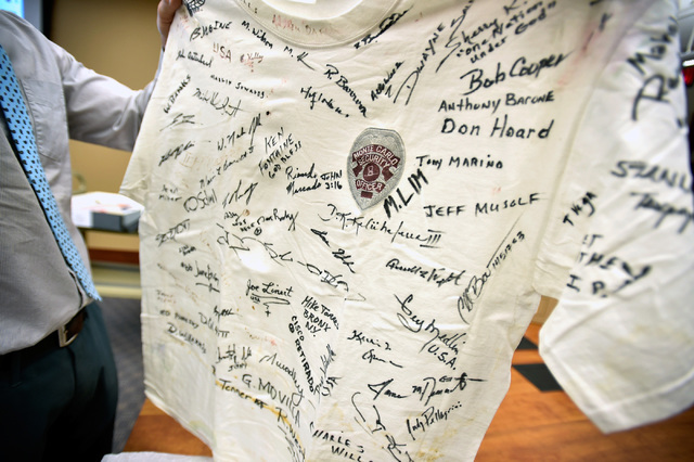 David Schwartz, Director of UNLV's Center for Gaming Research, displays one of the several thousand T-shirts that has been curated from t the New York-New York Hotel and Casino's 9-11 heroes tribu ...