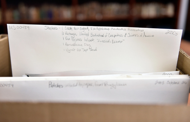 An archive box is seen labeled with its contents gathered from the New York-New York Hotel and Casino's 9-11 heroes tribute memorial Wednesday, Sept. 7, 2016, in Las Vegas. The library, with finan ...