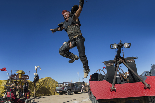 Steve Scholz leaps from his jeep during the seventh annual Wasteland Weekend on Friday, Sept. 23, 2016, in California City, Calif. The four day, post-apocalyptic festival takes place in the Mojave ...