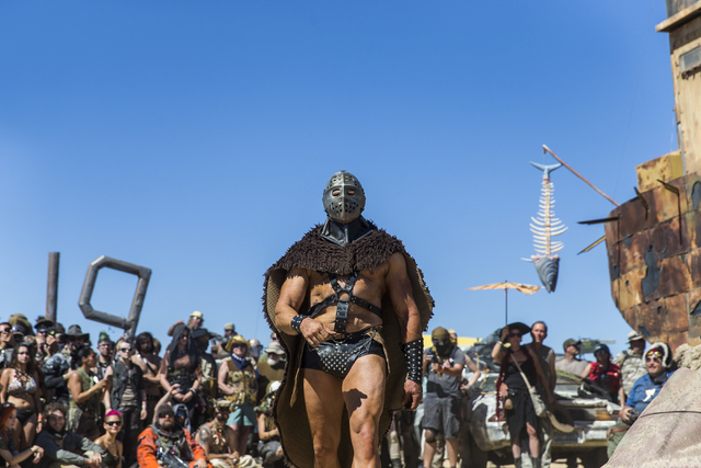 Humungus makes his entrance during the post-apocalyptic swimsuit contest during the seventh annual Wasteland Weekend on Saturday, Sept. 24, 2016, in California City, Calif. The four day, post-apoc ...