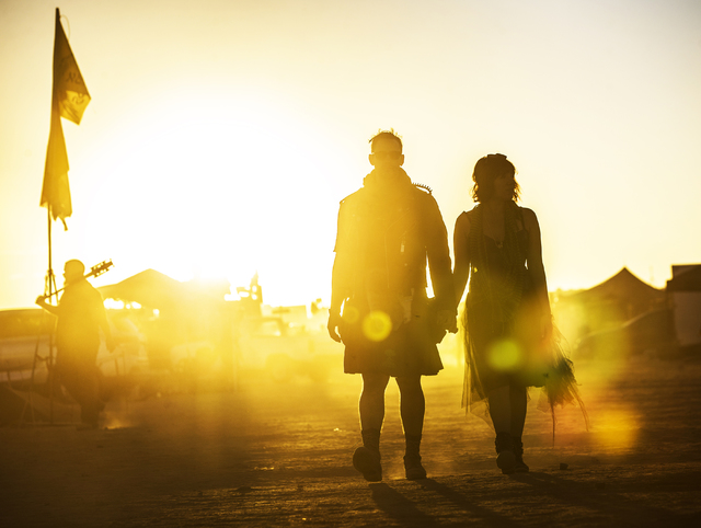Will Gillaspy, left, and Sonia Soleno walk to a show during the seventh annual Wasteland Weekend on Saturday, Sept. 24, 2016, in California City, Calif. The four day, post-apocalyptic festival tak ...