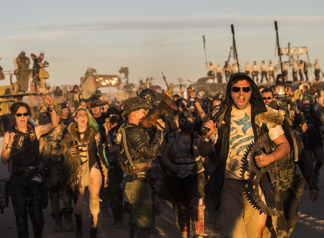 A large crowd of festival goers march through the camp ground during the seventh annual Wasteland Weekend on Saturday, Sept. 24, 2016, in California City, Calif. The four day, post-apocalyptic fes ...