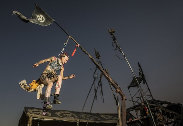 Maee Kroft swings from hooks attached to her skin, a practice known as suspension, during the seventh annual Wasteland Weekend on Saturday, Sept. 24, 2016, in California City, Calif. The four day, ...