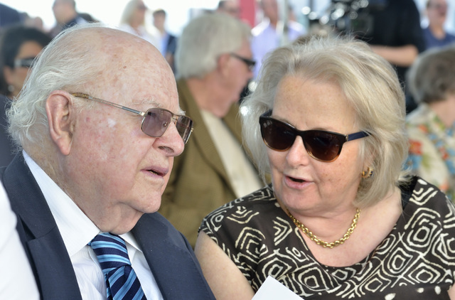 Len Ainsworth, founder and executive chairman of Ainsworth Game Technology, left, and his wife Gretel talk before the start of grand opening ceremonies for the company’s new North American  ...
