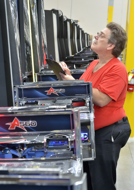 Quality assurance inspector Ron Corbin checks machines on the assembly line in the manufacturing area of the new North American headquarters for Ainsworth Game Technology at 5800 Rafael Rivera Way ...