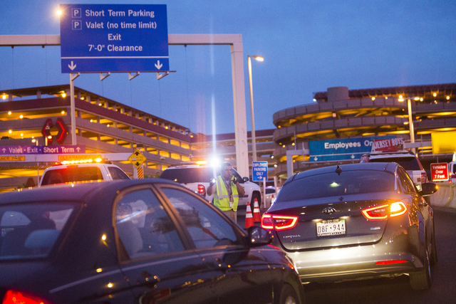 Law enforcement redirect traffic after two people were shot in a domestic incident in the parking garage at McCarran International Airport on Monday, Sept. 19, 2016, in Las Vegas. (Benjamin Hager/ ...