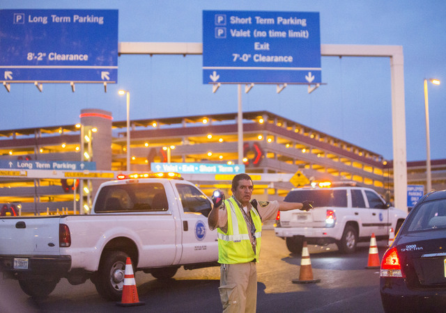 Law enforcement redirect traffic after two people were shot in a domestic incident in the parking garage at McCarran International Airport on Monday, Sept. 19, 2016, in Las Vegas. Benjamin Hager/L ...