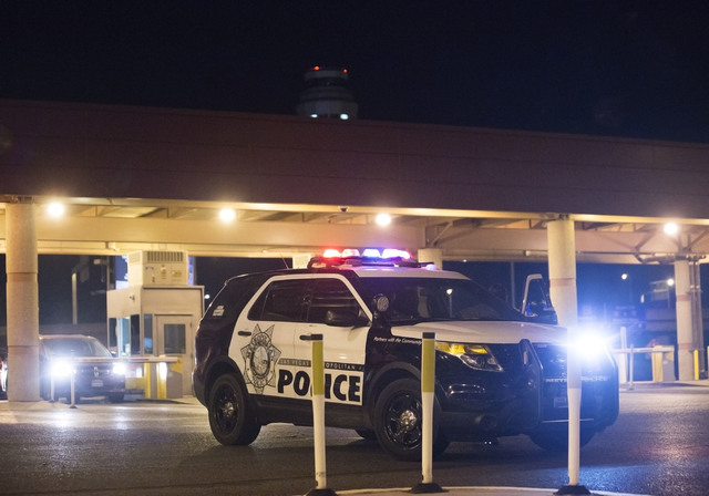Law enforcement redirect traffic after two people were shot in a domestic incident in the parking garage at McCarran International Airport on Monday, Sept. 19, 2016, in Las Vegas. Benjamin Hager/L ...