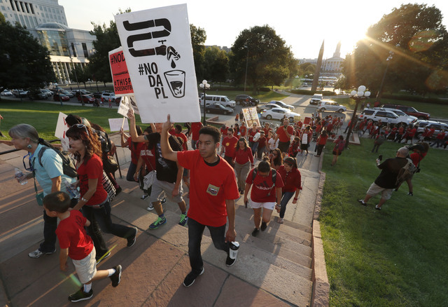 A line of protesters against the construction of the Dakota Access oil pipeline on the Standing Rock Reservation in North Dakota head to a unity rally on the west steps of the State Capitol late T ...