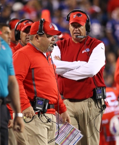 Buffalo Bills offensive coordinator Greg Roman, left, and head coach Rex Ryan, right, work the sidelines during the first half of an NFL football game against the New York Jets on Thursday, Sept.  ...