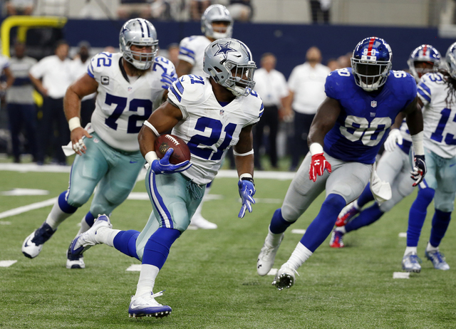 Dallas Cowboys running back Ezekiel Elliott (21) runs the ball for a touchdown as New York Giants defensive end Jason Pierre-Paul (90) pursues in the second half of an NFL football game, Sunday Se ...