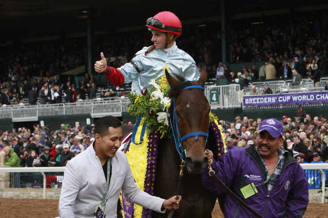 Jockey Florent Geroux sits on Mongolian Saturday in the winner's circle after winning the Breeders' Cup Turf Sprint horse race at Keeneland race track Saturday, Oct. 31, 2015, in Lexington, Ky. (G ...