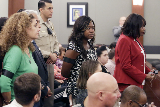 Public defenders, including Belinda Harris, center, wearing a Black Lives Matter button, listen as Erika Ballou, not photographed, presents her argument Thursday, Sept. 22, 2016, at the Regional J ...