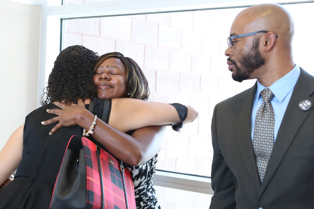 Erika Ballou, left, is embraced by Belinda Harris as she leaves the courtroom after being told by District Judge Douglas Herndon not to wear a Black Lives Matter pin inside the courtroom as Jonath ...