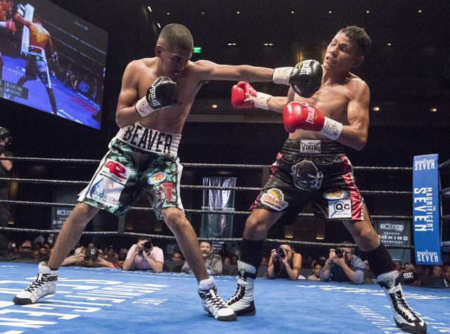 Alexis Santiago lands a punch against Jose Cayetano during the NABF super bantamweight fight at the Cosmopolitan hotel-casino in Las Vegas on Friday, Sept. 16, 2016. (Loren Townsley/Las Vegas Revi ...