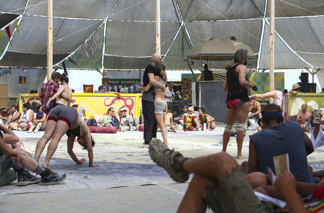Attendees relax and do yoga at the center camp cafe during Burning Man at the Black Rock Desert north of Reno on Wednesday, Aug. 31, 2016. Chase Stevens/Las Vegas Review-Journal Follow @csstevensphoto