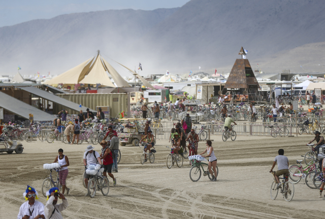 Attendees bike around the center camp at Burning Man at the Black Rock Desert north of Reno on Wednesday, Aug. 31, 2016. Chase Stevens/Las Vegas Review-Journal Follow @csstevensphoto
