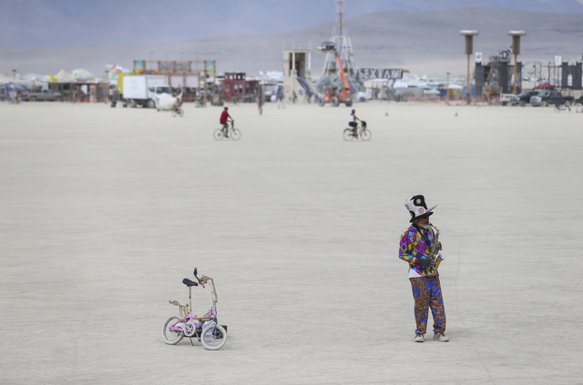 Al Barney, also known as &quot;Captain Drift,&quot; plays saxophone on the playa during Burning Man at the Black Rock Desert north of Reno on Wednesday, Aug. 31, 2016. Chase Stevens/Las Ve ...