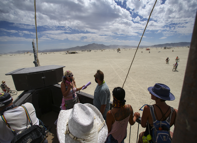 &quot;Dazzle!,&quot; her playa name, leads an art tour aboard an art car, the USS Nevada, during Burning Man at the Black Rock Desert north of Reno on Wednesday, Aug. 31, 2016. Chase Steve ...