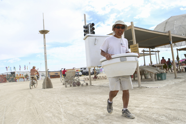 Gordon Hamachi walks around dressed as a toilet during Burning Man at the Black Rock Desert north of Reno on Wednesday, Aug. 31, 2016. He started dressing as a toilet because it is &quot;somet ...