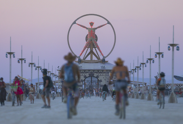 The Burning Man effigy, modeled after the Leonardo da Vinci's Vitruvian Man, stands above the playa during Burning Man at the Black Rock Desert north of Reno on Wednesday, Aug. 31, 2016. Chase Ste ...