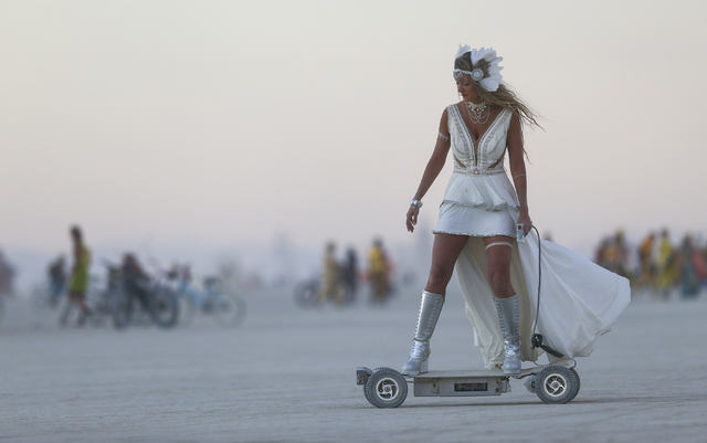 A woman rides an electric scooter during Burning Man at the Black Rock Desert north of Reno on Wednesday, Aug. 31, 2016. Chase Stevens/Las Vegas Review-Journal Follow @csstevensphoto