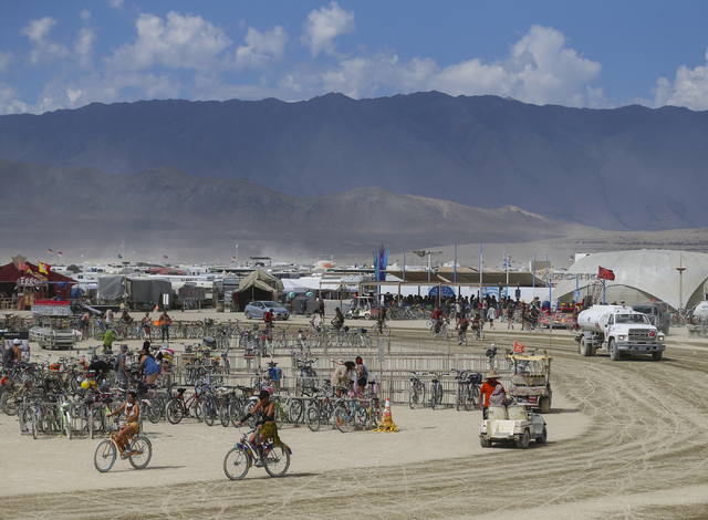 Attendees pass through the center camp area during Burning Man at the Black Rock Desert north of Reno on Wednesday, Aug. 31, 2016. Chase Stevens/Las Vegas Review-Journal Follow @csstevensphoto