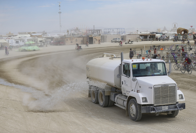 A truck sprays water outside on the ground outside of the center camp cafe during Burning Man at the Black Rock Desert north of Reno on Wednesday, Aug. 31, 2016. Chase Stevens/Las Vegas Review-Jou ...