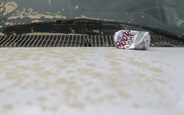 An empty can of Coors Light sits on the dusty hood of a car during Burning Man at the Black Rock Desert north of Reno on Wednesday, Aug. 31, 2016. Chase Stevens/Las Vegas Review-Journal Follow @cs ...