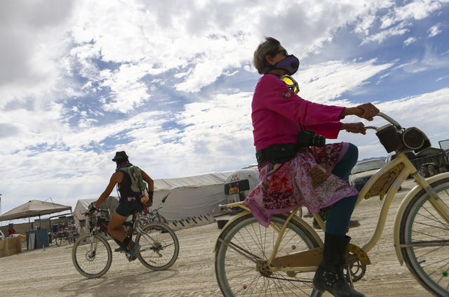 Attendees on bikes pass by during Burning Man at the Black Rock Desert north of Reno on Wednesday, Aug. 31, 2016. Chase Stevens/Las Vegas Review-Journal Follow @csstevensphoto