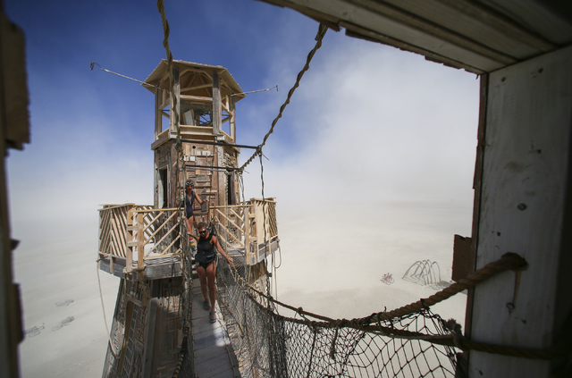 Attendees explore The Black Rock Lighthouse Service art installation during Burning Man at the Black Rock Desert north of Reno on Thursday, Sept. 1, 2016. Chase Stevens/Las Vegas Review-Journal Fo ...