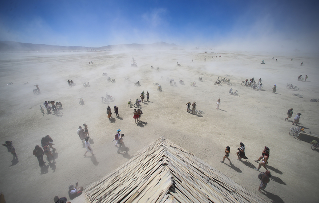 Attendees approach the Catacomb of Veils art installation as dust kicks up along the playa during Burning Man at the Black Rock Desert north of Reno on Thursday, Sept. 1, 2016. Chase Stevens/Las V ...
