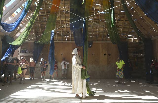 Luis Navarrete, center, of Portland, Ore., walks through the Catacomb of Veils art installation during Burning Man at the Black Rock Desert north of Reno on Thursday, Sept. 1, 2016. Chase Stevens/ ...