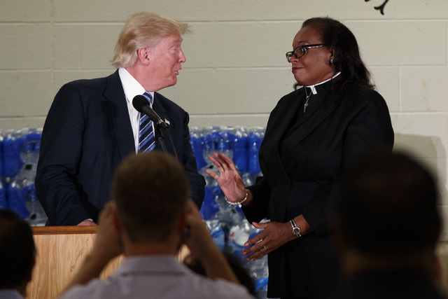 Rev. Faith Green Timmons interrupts Republican presidential candidate Donald Trump as he spoke during a visit to Bethel United Methodist Church, Wednesday, Sept. 14, 2016, in Flint, Mich. (Evan Vu ...
