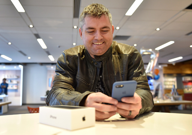 Larry Simpson tries out a new iPhone 7 at an AT&T store Friday, Sept. 16, 2016, in Las Vegas.  Apple's newest iPhone went on sale on Friday featuring an all-new advanced camera system, dust an ...