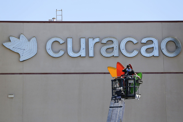 A worker hangs a sign for Curacao, a new tenant at Meadows mall in Las Vegas on Thursday, Sept. 15, 2016. (Brett Le Blanc/Las Vegas Review-Journal Follow @bleblancphoto)