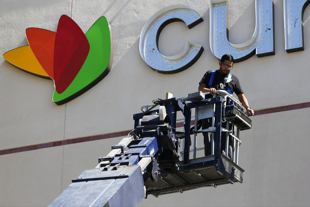 A worker hangs a sign for Curacao, a new tenant at Meadows mall in Las Vegas on Thursday, Sept. 15, 2016. (Brett Le Blanc/Las Vegas Review-Journal Follow @bleblancphoto)