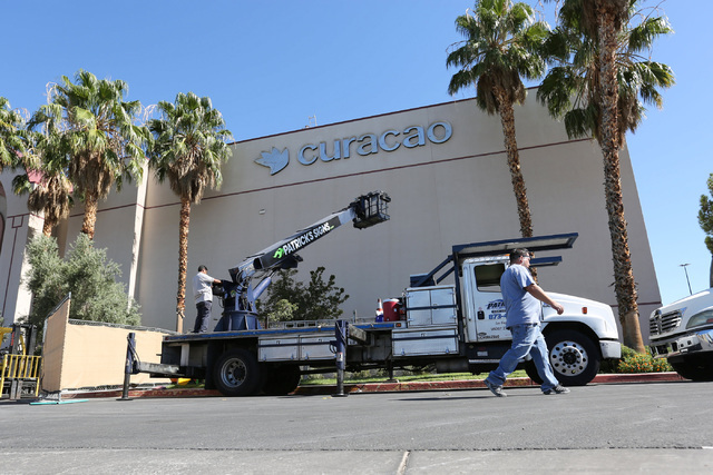 Workers hang a sign for Curacao, a new tenant at the Meadows Mall in Las Vegas on Thursday, Sept. 15, 2016. Brett Le Blanc/Las Vegas Review-Journal Follow @bleblancphoto