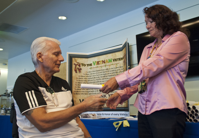 Ron Cantagallo receives a pin in honor of his service during the Vietnam War area from peer support specialist Geri Hunt at the VA Medical Center in North Las Vegas on Thursday, Sept. 15, 2016.  ( ...