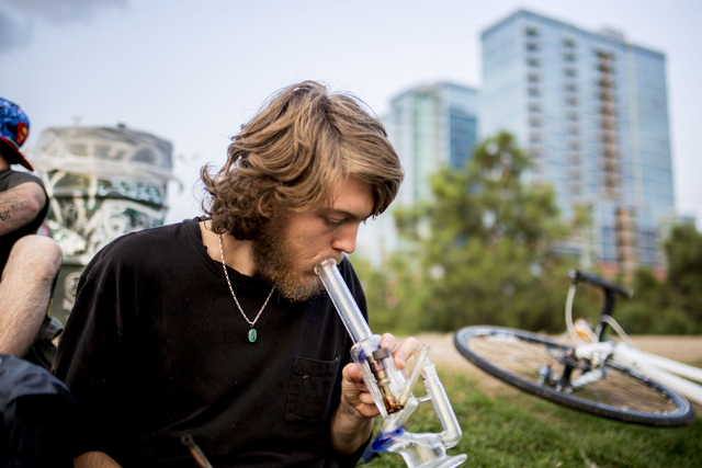 Denver Colorado local Atticus, takes a hit of marijuana in Commons Park, Wednesday, Aug. 31, 2016, in Denver. Elizabeth Page Brumley/Las Vegas Review-Journal Follow @ELIPAGEPHOTO